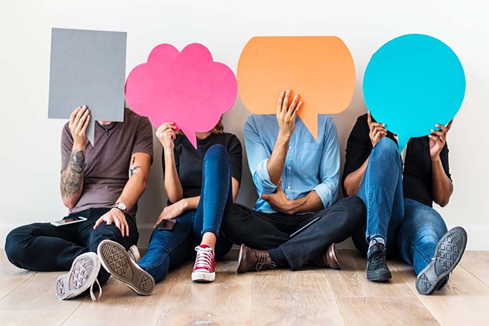 people sitting holding speech bubbles