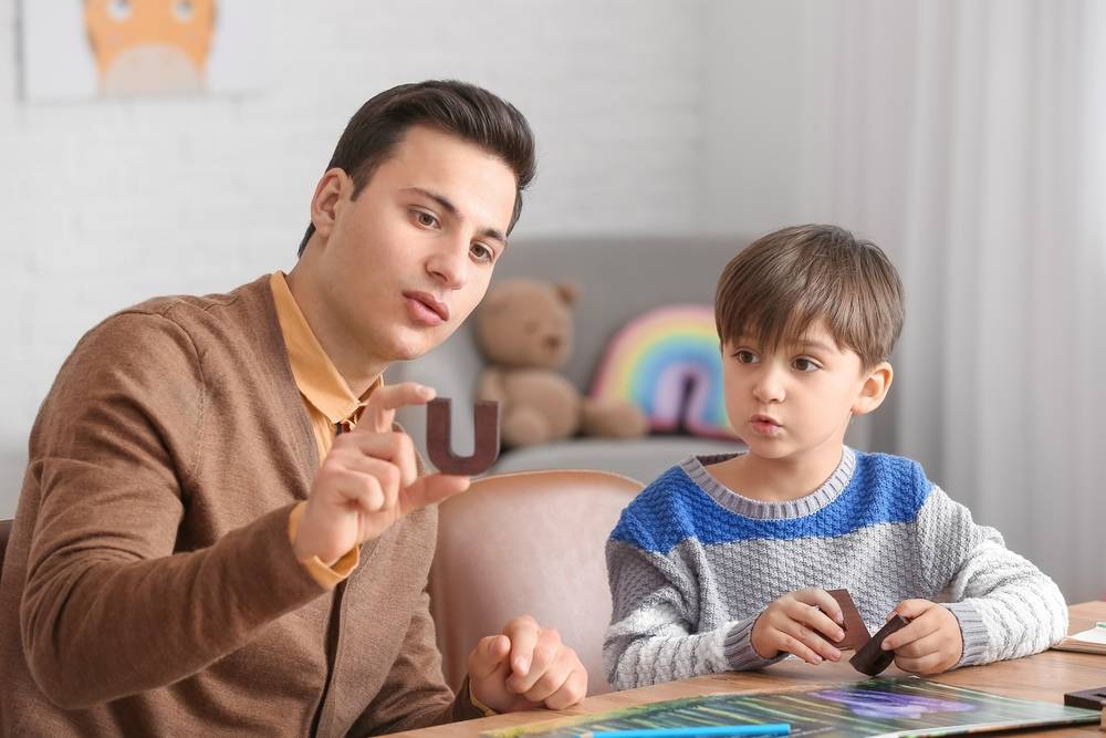 Speech therapist working with child