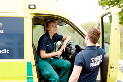 Two paramedic students with the emergency training ambulance