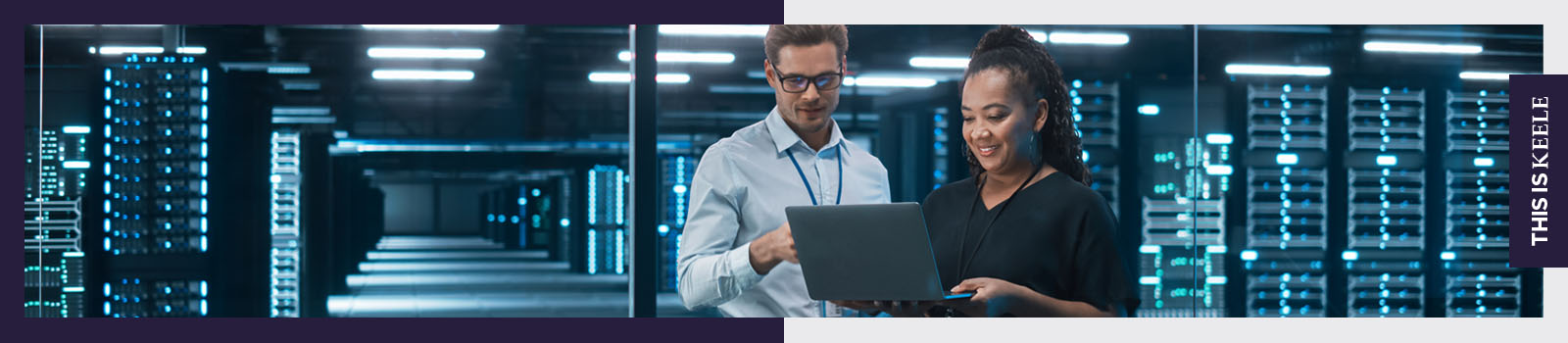 A male and a female looking at a laptop in an office